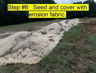 An Image of the above ground burial soil soil mound covered with erosion fabric.