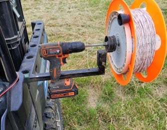 2e. A standard extension cord reel adapted for use with a battery-powered drill eliminates the need to reel up poly wire by hand.